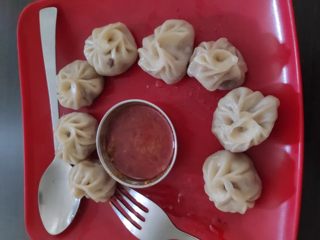 Steamed momos with spicy achar